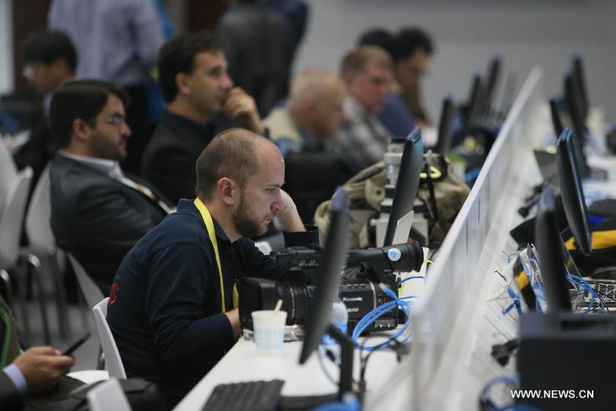 Journalists work at the media center of the fourth summit of the Conference on Interaction and Confidence Building Measures in Asia (CICA) in east China's Shanghai, May 21, 2014. The fourth CICA summit began in Shanghai on Wednesday morning. (Xinhua/Pei Xin) 