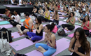 People practice yoga in Times Square to mark Summer solstice