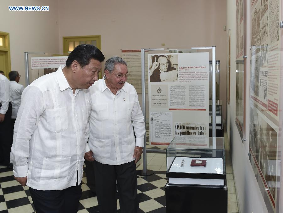 Chinese President Xi Jinping (L), with the accompany of Cuban leader Raul Castro, visits Moncada Barracks, where former Cuban leader Fidel Castro launched a failed assault on July 26, 1953, at Santiago de Cuba, the Cuban "Heroic City," July 23, 2014. Xi visited Santiago de Cuba, the second largest city of Cuba, on Wednesday. (Xinhua/Lan Hongguang)