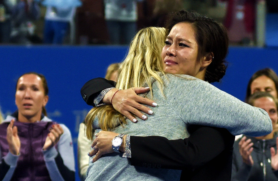 China's tennis great Li Na cries as she hugs two-time Wimbledon winner Petra Kvitova at her retirement ceremony during the China Open in Beijing on Sept. 30, 2014. (Li Zhenyu/People's Daily Online)