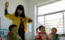 Beautiful teacher and her kindergarten on mountaintop