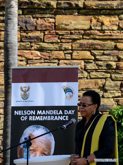 Graca Machel, widow of Nelson Mandela, speaks before the Mandela statue in the Union Buildings, Pretoria, South Africa, on Dec.5, 2014. A wreath laying ceremony was held here Friday to mark the 1st anniversary of late South Africa's President Nelson Mandela's passing. South Africa's veterans of the struggle for freedom and those who fought with Nelson Mandela against apartheid were invited to lead the wreath laying. (Xinhua/Zhai Jianlan) 