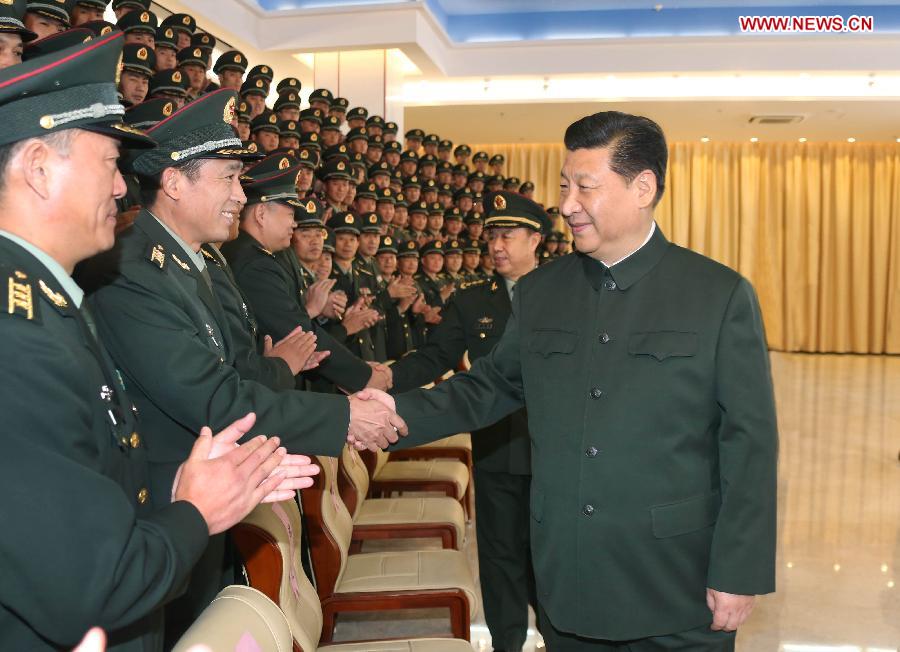 Chinese President Xi Jinping (R), also general secretary of the Central Committee of the Communist Party of China and chairman of the Central Military Commission, meets with officers of the Chinese People's Liberation Army Garrison in the Macao Special Administrative Region (SAR) in Macao, south China, Dec. 20, 2014. (Xinhua/Li Gang)