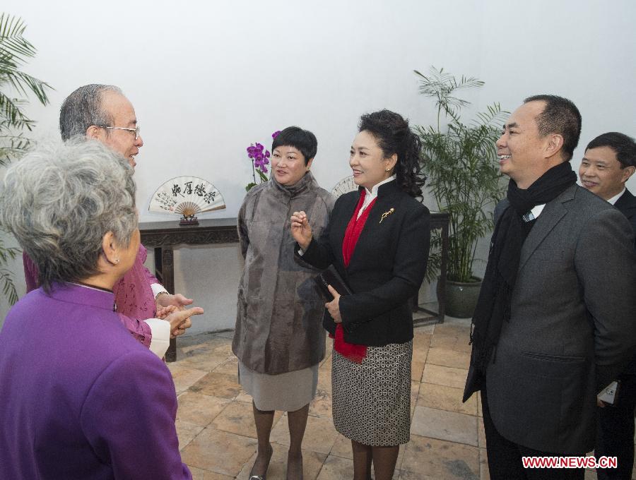Chinese President Xi Jinping's wife Peng Liyuan (3rd R) talks with artists of the Cantonese Naamyam, a narrative folk singing popular in the Pearl River Delta region, during her visit to the Family House of Zheng Guanying with the company of Fok Wai Fun (3rd L), wife of the Macao Special Administrative Region's chief executive Chui Sai On, in south China's Macao, Dec. 20, 2014. Zheng Guanying, a late-Qing Dynasty (1644-1911) philosopher and writer, completed his acclaimed masterpiece Words of Warning in Times of Prosperity in the complex. (Xinhua/Wang Ye)