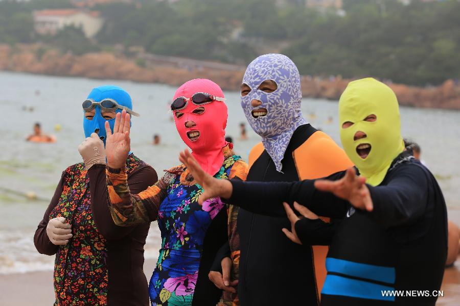 Models display new creations of facekini collection featuring Chinese  cultural elements on the beach during a press conference in Qingdao city,  east C Stock Photo - Alamy
