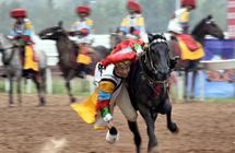 Tibetan athletes perform horse racing at ethnic minorities games