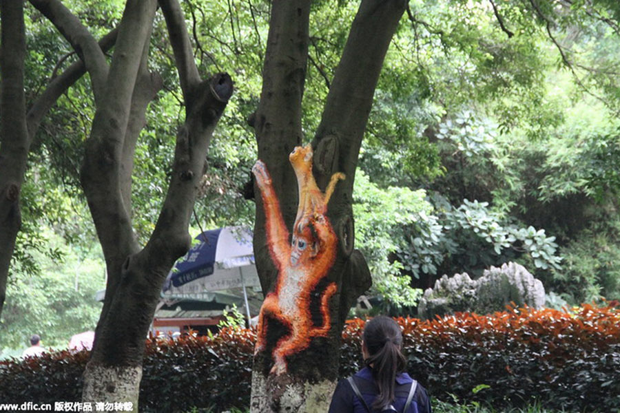 Animals illustration appear on tree trunks in Guilin City Park