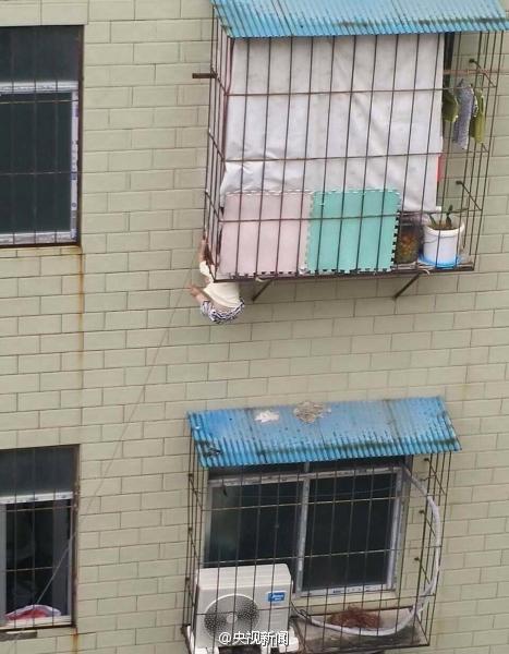 Man saved baby stuck in  window rails on fourth floor