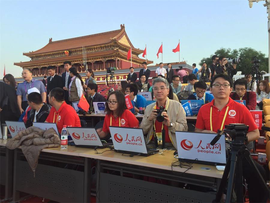 People's Daily Online reporters get ready for a live broadcast of V-Day parade