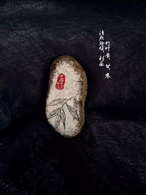 Doctor draws traditional Chinese medicines on stones