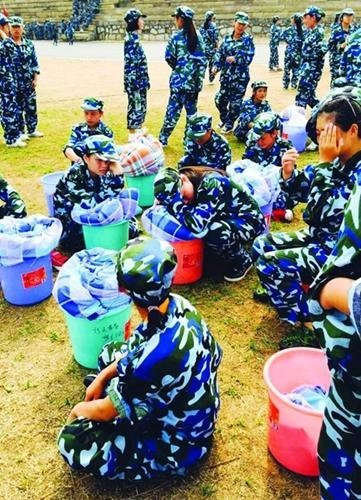 Weird punishment: College freshmen bathe in sunshine in quilts during military training