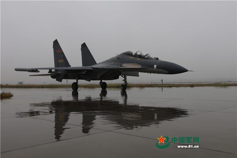 J11 fighters conduct drill in rain