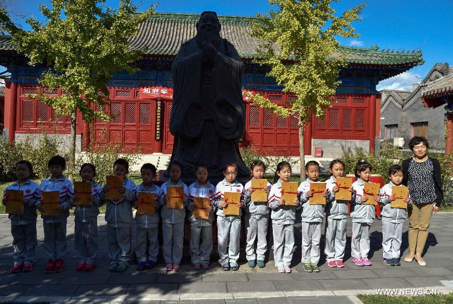Pupils attend entrance ceremony at Confucian Temple in Beijing 