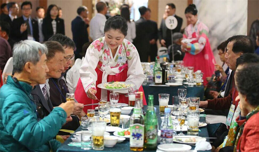 Beautiful DPRK waitresses in Korean families reunion dinner