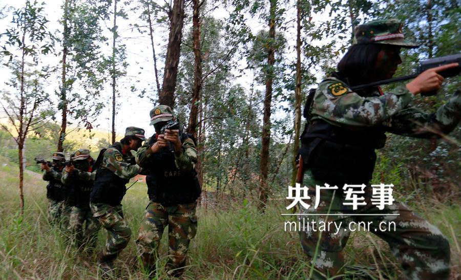 Female soldier of armed police force climbs cliff barehanded