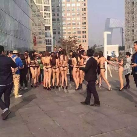 Young women strip to their underwear for a publicity stunt