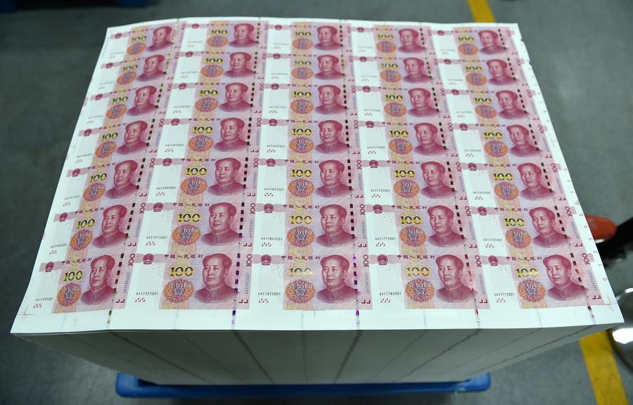 43 armored cash-in-transit vans wait in line to transport new 100-yuan banknotes