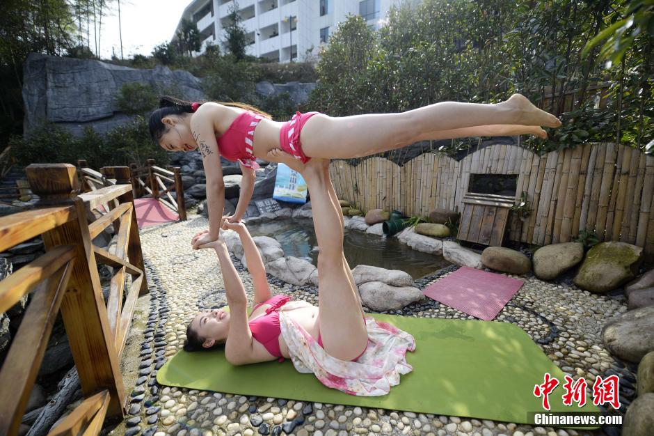 Bikini yoga fans practice in spring