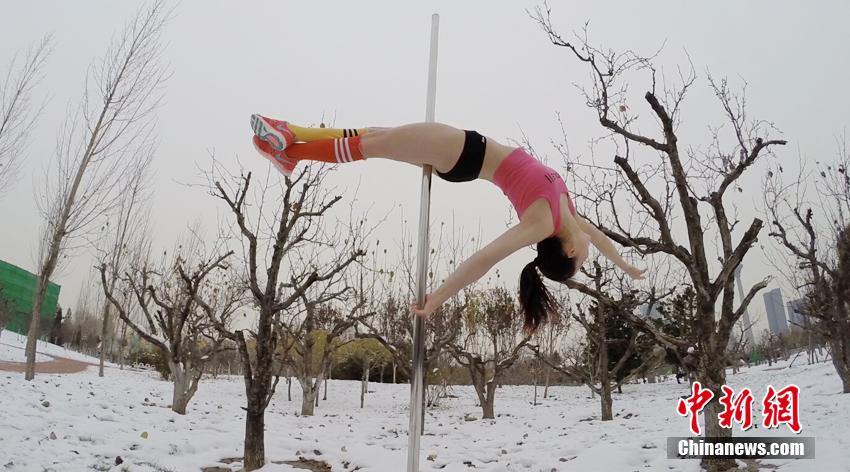 Pole dancers perform in snow