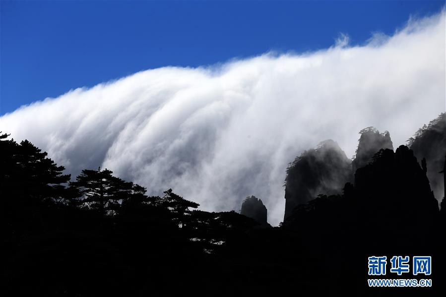 Incredible moments when cloud rolls over cliff tops like a waterfall