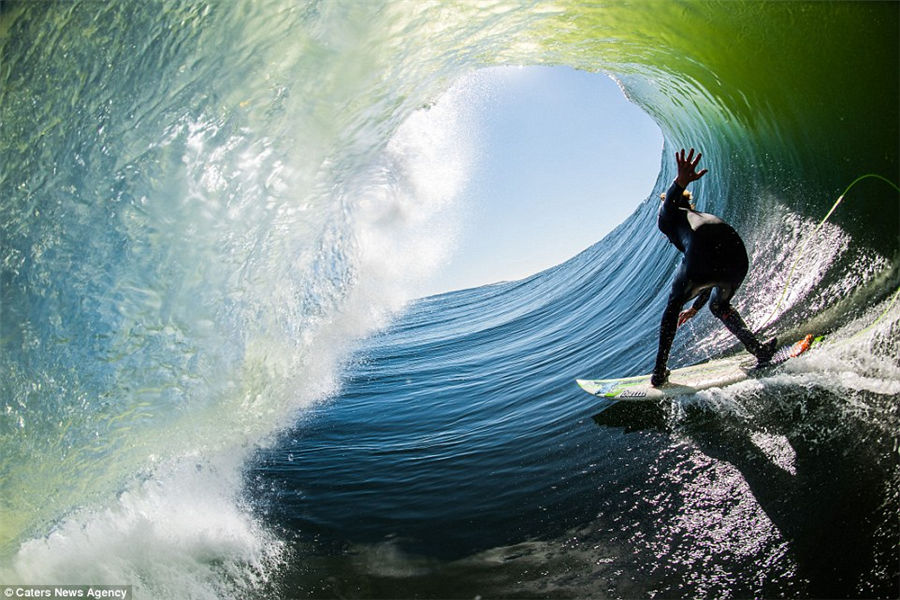 Teenager captures incredible photos of pro-surfers riding huge waves from inside the barrel as he tags along behind them
