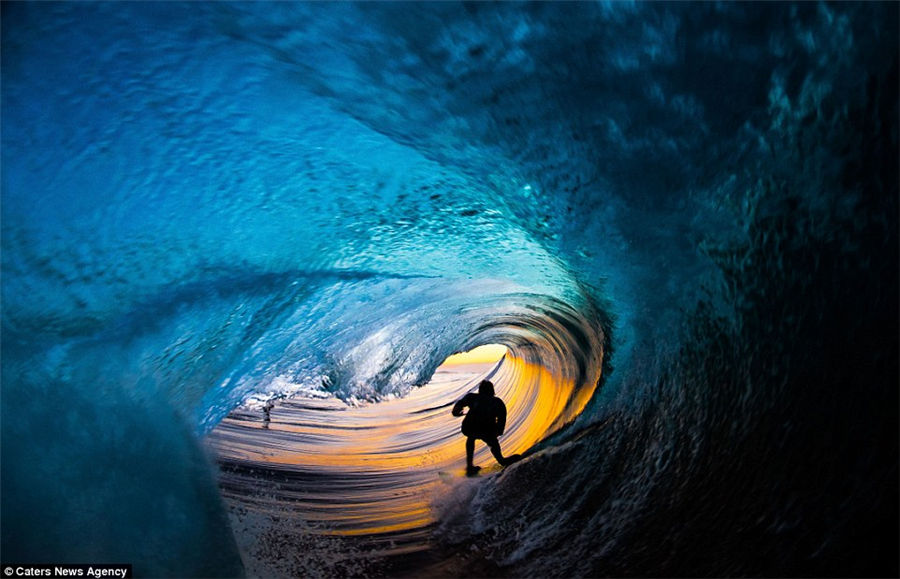 Teenager captures incredible photos of pro-surfers riding huge waves from inside the barrel as he tags along behind them
