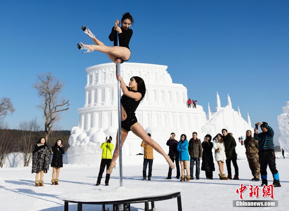 Women perform pole dancing in low temperature
