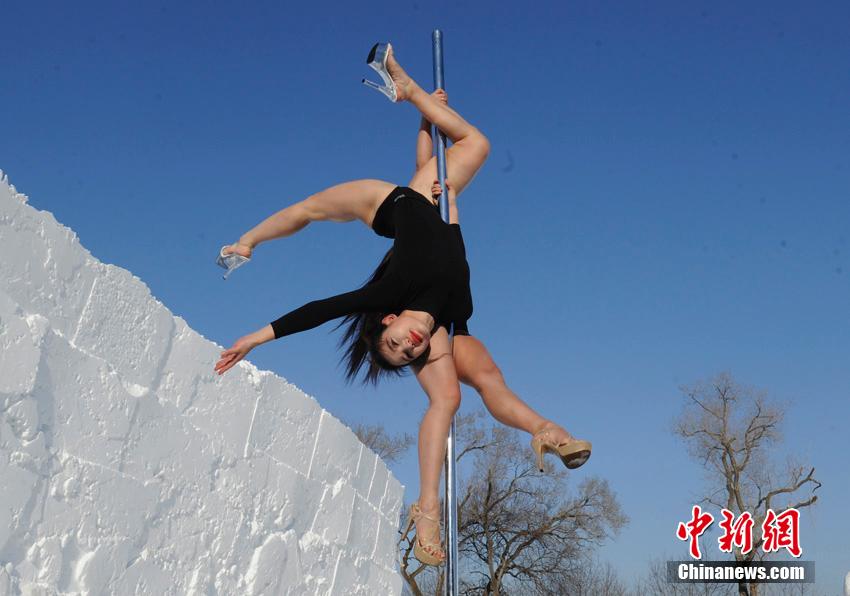 Women perform pole dancing in low temperature