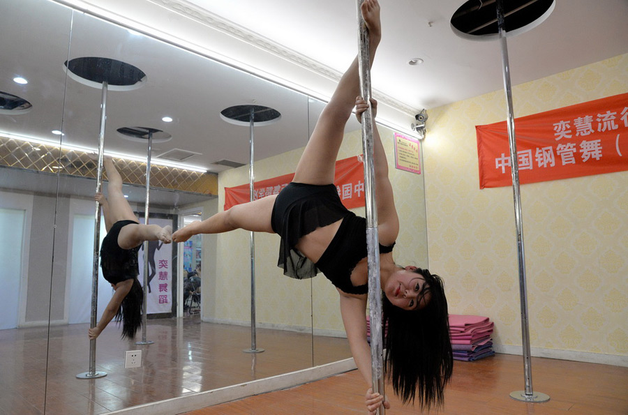 Pole dance enthusiasts in training