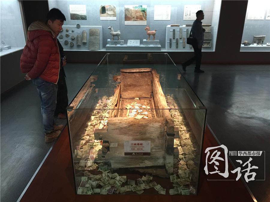 Human remains in museum covered by coins and banknotes thrown by tourists