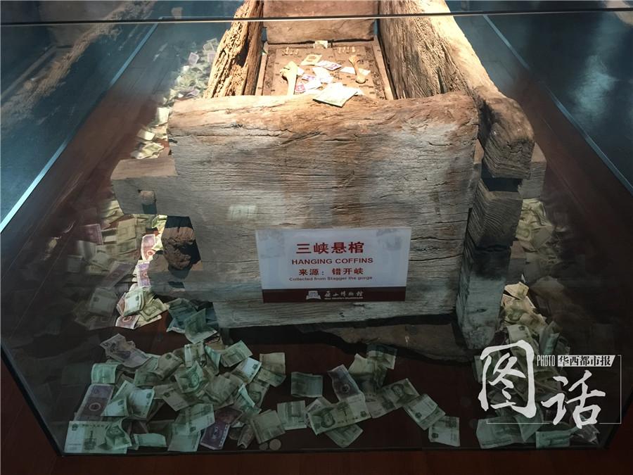 Human remains in museum covered by coins and banknotes thrown by tourists