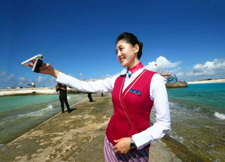 Chinese stewardess celebrate test flight at Nansha Islands airfield