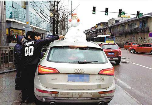 Snowman on top of car gets driver in trouble