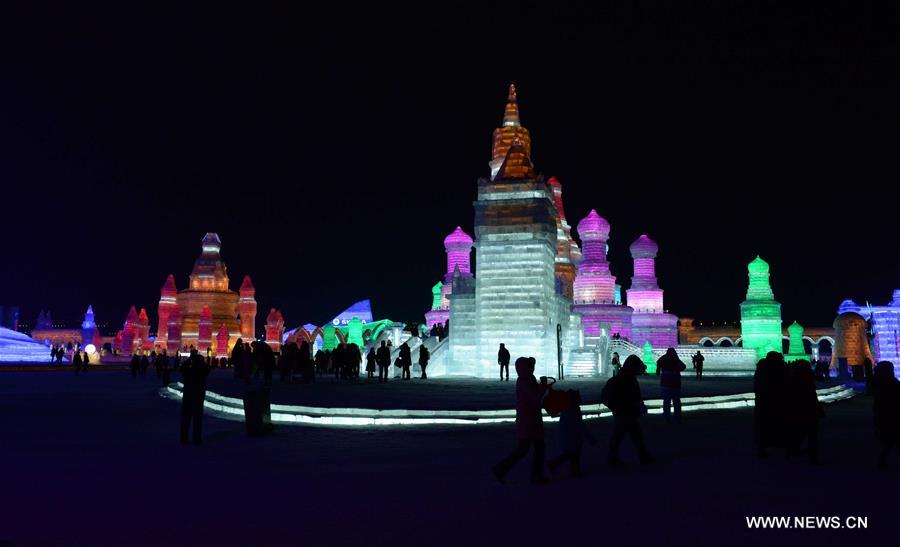 Tourists view shimmering ice sculptures in China's Harbin