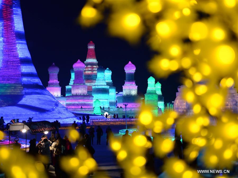 Tourists view shimmering ice sculptures in China's Harbin