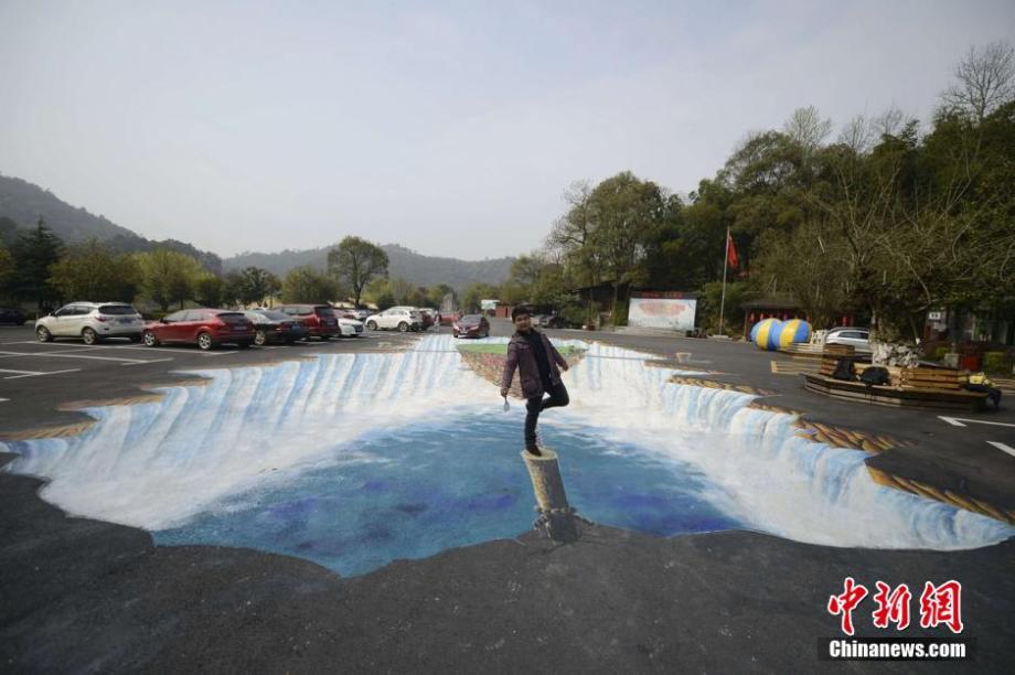 Giant 3D waterfall painted on parking lot in C China