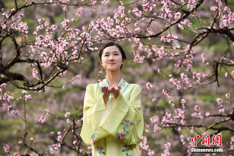 College girls in ancient costume promote peach blossom festival