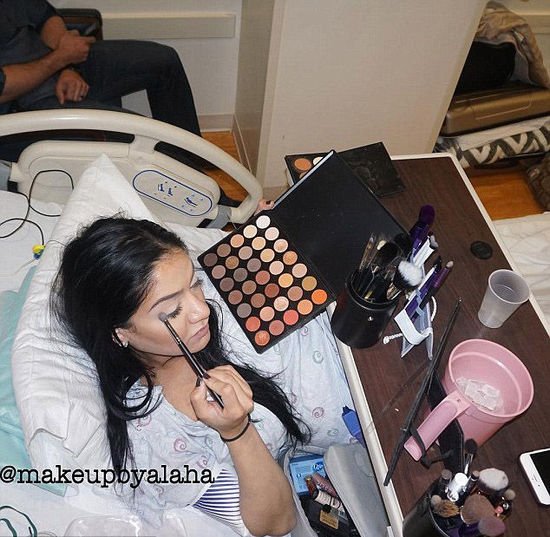 American woman puts on full face make-up in the middle of giving birth