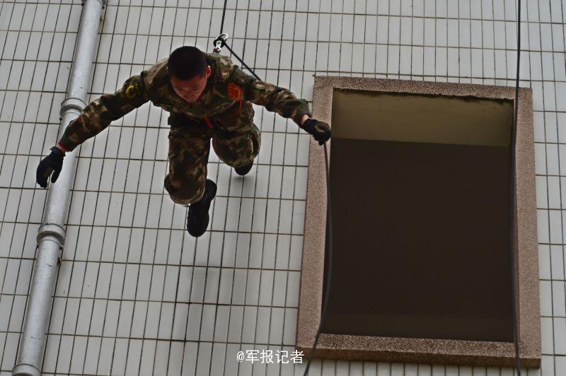 SWAT members run on the wet wall in training