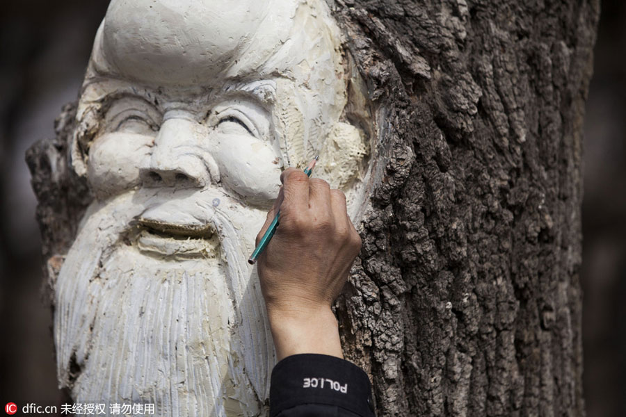 Carved figures emerge from trees in Northeast China