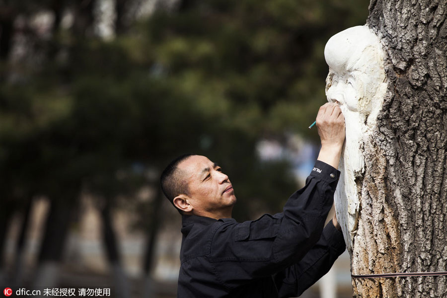 Carved figures emerge from trees in Northeast China