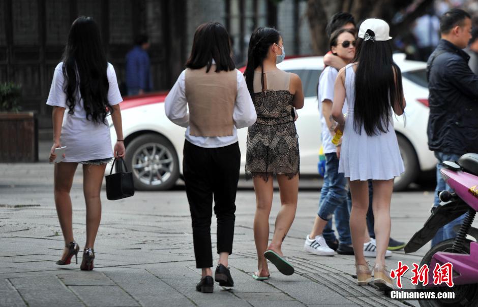 Stylish women in summer dress in street of Fuzhou