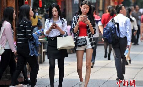 Stylish women in summer dress in street of Fuzhou