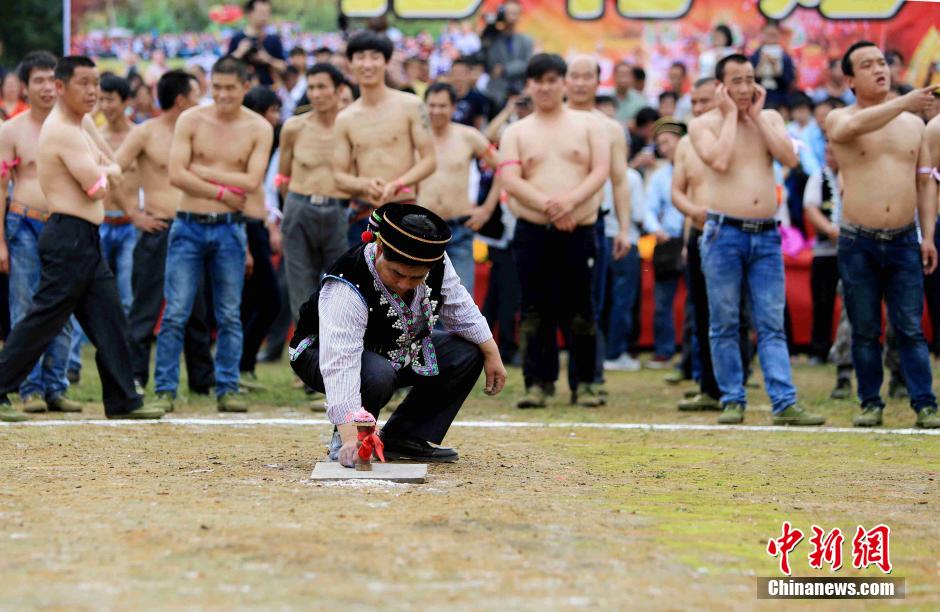 Half-naked men scramble for fireworks in Guangxi