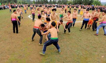 Half-naked men scramble for fireworks in Guangxi