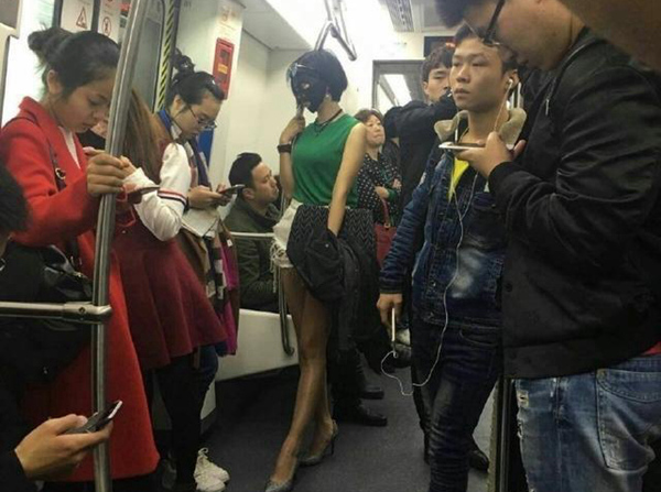 Woman rides subway wearing facial mask