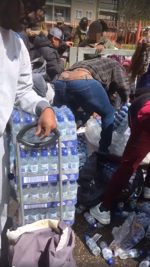 The London Loot-athon: Outrage as dozens of people are filmed brazenly snatching bottles of water left for marathon runners