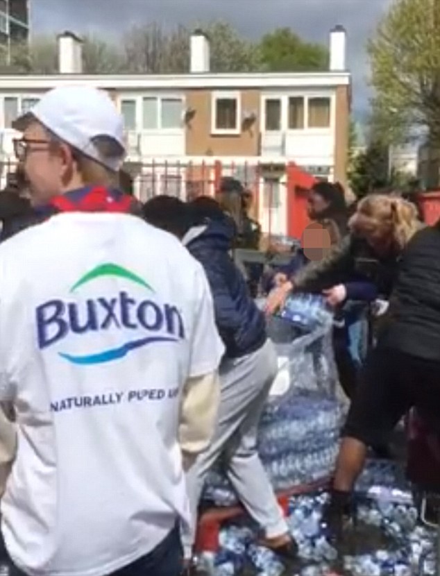 The London Loot-athon: Outrage as dozens of people are filmed brazenly snatching bottles of water left for marathon runners