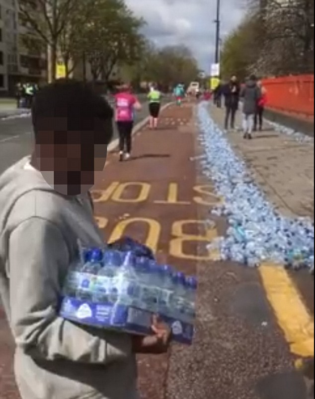 The London Loot-athon: Outrage as dozens of people are filmed brazenly snatching bottles of water left for marathon runners