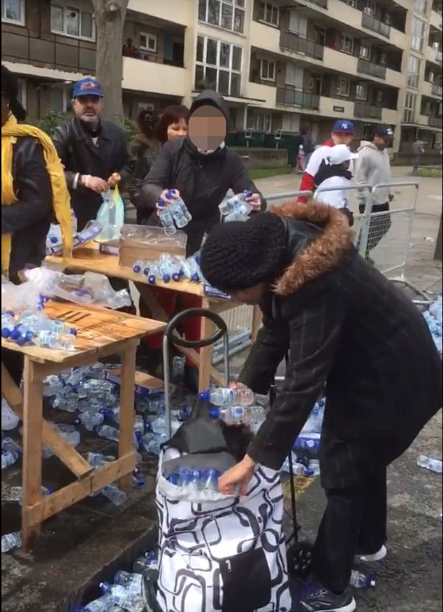 The London Loot-athon: Outrage as dozens of people are filmed brazenly snatching bottles of water left for marathon runners